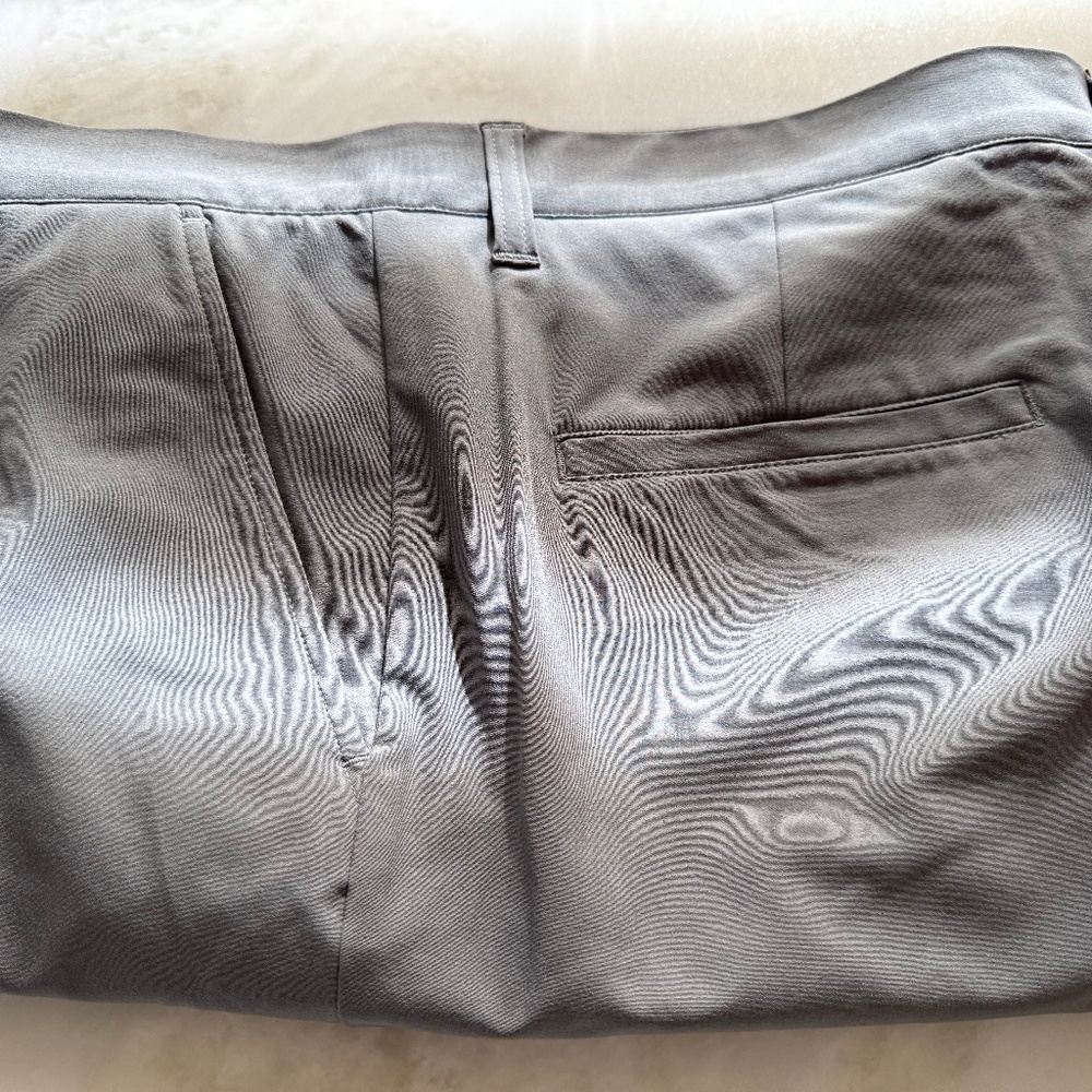 Man’s golf shorts by Adidas. Size 35 in light gray.